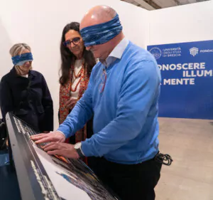 Futura Expo 2025, Brescia. Ivana Passamani leads the Rector and the DG of the University of Brescia in tactile exploration.